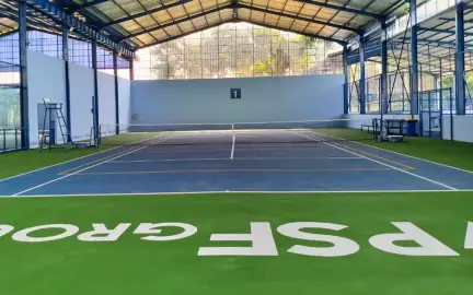 Indoor tennis court with PSF Group lettering